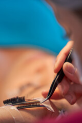 Eyelash Extension Procedure. Woman Eye with Long Eyelashes. Lashes. With Mask Medicinal Covid.