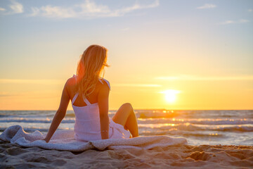 Fototapeta na wymiar Calm woman on beach during sundown