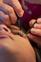Eyelash Extension Procedure. Woman Eye with Long Eyelashes. Lashes. With Mask Medicinal Covid.