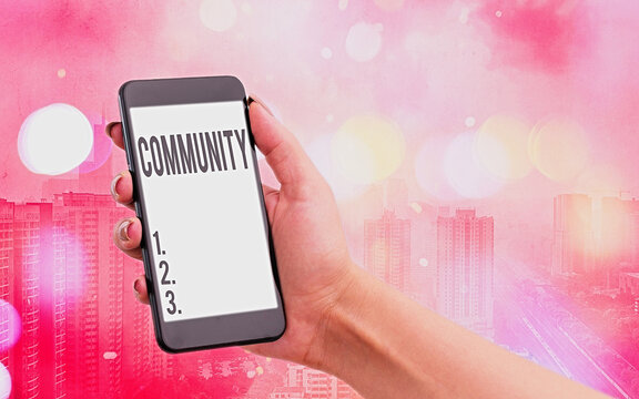 Handwriting text Community. Conceptual photo group of showing with a common characteristics living together Modern gadgets with white display screen under colorful bokeh background