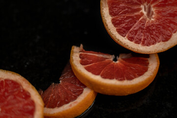 Grapefruit close up on black stone background