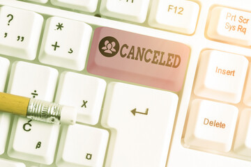 Conceptual hand writing showing Canceled. Concept meaning to decide not to conduct or perform something planned or expected White pc keyboard with note paper above white key copy space - obrazy, fototapety, plakaty