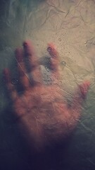 Wet hand behind the semi transparent layer