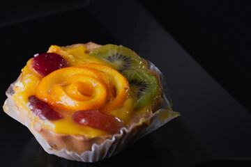 Cheese dessert with orange on a black background