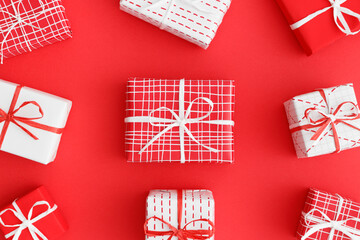 Fototapeta premium Red and white christmas gifts on a red background.