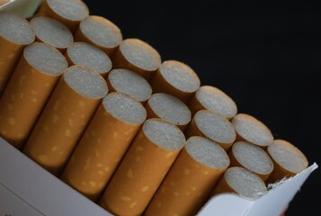 Cigarettes in a pack on a black background