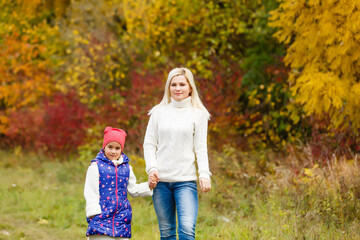 Fototapeta premium family, childhood, season and people concept - happy family in autumn park