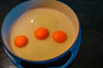 Three raw eggs in a bowl