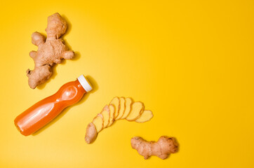 Ginger in different conditions: fresh, dry root, pills and cut plant on pastel yellow orange background.