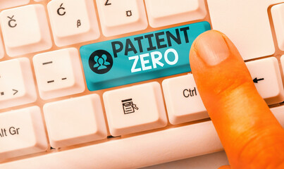 Conceptual hand writing showing Patient Zero. Concept meaning primary disease carrier of the highlycontagious disease White pc keyboard with empty note paper above white key copy space