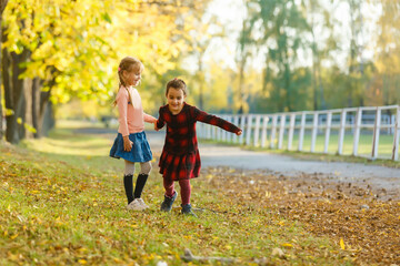 two little girls in autumn park