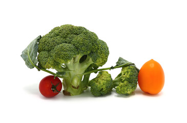 Raw Inflorescences of broccoli and tomatoes of different colors and sizes on a light background. Natural product. Natural hue. Close-up.