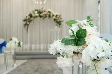 Bright room for weddings. Rows of guest chairs decorated with blue cloth