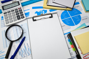 Obraz premium business office desk closeup - financial reports, analysis and accounting, set of documents, tables and graphs, various items for bookkeeping, calculator