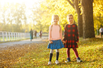 Fototapeta premium two little girls in autumn park