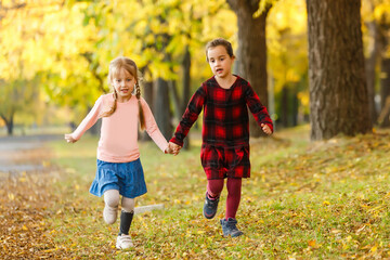 Naklejka na ściany i meble two little girls in autumn park