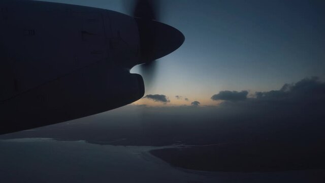 Aerial view of airplane propeller over dark cloudy sky