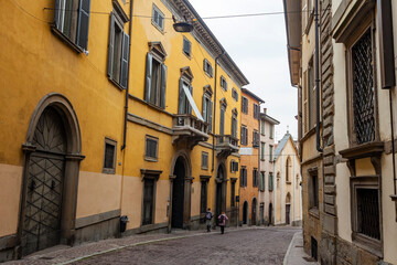 Bergamo, Italy, February 16, 2020. Picturesque trade street in the Lower City (Citta Bassa). People go along the street
