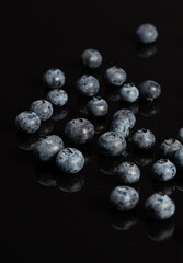 Blueberries on the black glass with nice reflection