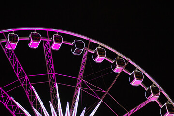 Beautiful view of the Ferris wheel at night. Night illumination of the high Ferris wheel.