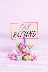 Writing note showing Tax Refund. Business concept for excess payment of paid taxes returned to...