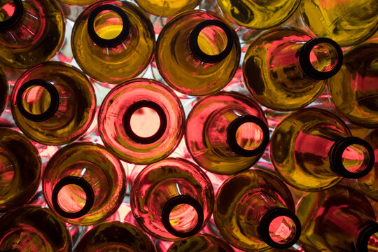 red glass empty beer bottles lie in rows