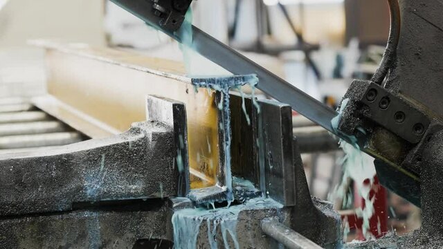 Close up video of professional metal saw cutting machine. This close up video shows a metal saw as it cuts a steel. 