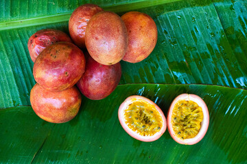 Ripe passion fruit, on a wet banana leaf. Vitamins, fruits, healthy foods