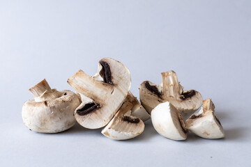 Fototapeta premium Mushrooms lies on a gray background. Champignons photographed at close range. . High quality photo