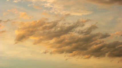 Naklejka na ściany i meble altostratus clouds during golden hour.