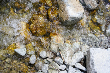 Mountain stream river with many rock stone. Natural outdoor flowing river background.