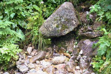 Mountain stream in Tatra Mountains. Stone and gravel in river. Water scenery.