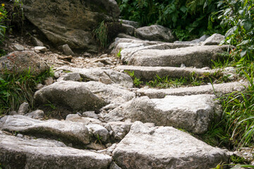 Natural stairs in mountains. Outdoor pathway in Tatra Mountains. Stairs made on stone. Mountains valley.