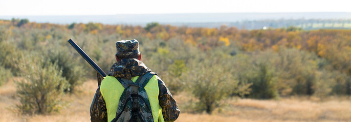 Hunters with a german drathaar and spaniel, pigeon hunting with dogs in reflective vests