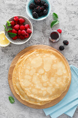 Thin crepes with fresh berries. Pancakes with raspberry and blackberry.