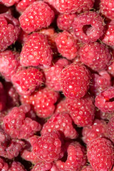 Macro photo of fresh raspberries. Background patern of sweet red raspberries.