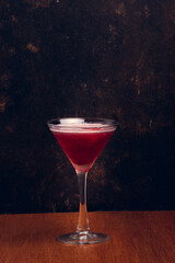 Fruit Martini on rustic background with space for text. Vertical shot.