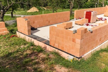 Construction of a small family house. House construction site. Brick wall on a construction site. A new house.