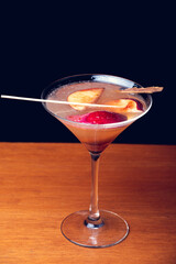 Gourmet mixology on black background with space for text. Fruit mixology. Vertical shot.