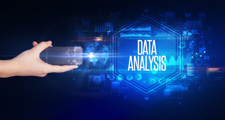 hand holding wireless peripheral with DATA ANALYSIS inscription, cyber security concept