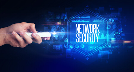 hand holding wireless peripheral with NETWORK SECURITY inscription, cyber security concept