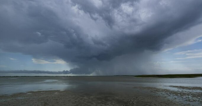 4K UHD time lapse with heavy storm and rain, clouds rolling over the lake 