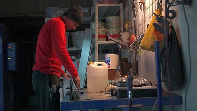 The worker's hand wipes the metal product with a cloth with a degreaser