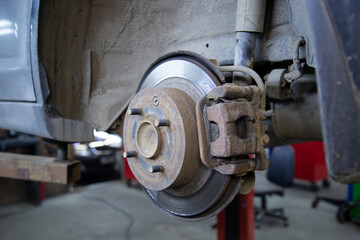 Fototapeta na wymiar Repair of car brake discs. Replacement of car brake pads.