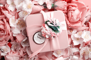box with gift  around roses  and  jasmine background. romantic and beauty concept
