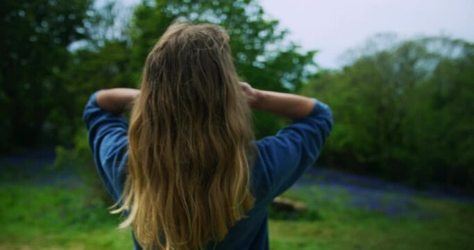 Young woman toucching her hair in a meadow