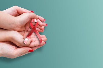 red aids ribbon in hand.