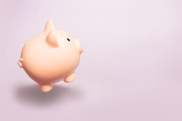 Money holding concept. Saving symbol - Piggy bank for coins on a pastel background. Copy space.
