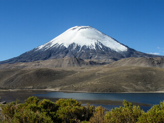 Fototapeta premium Shot of the perfectly shaped Parinacota Volcano located in the Lauca National Park in the very north of Chile, also known as Altiplano or highlands.