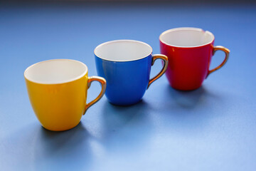 Three cups of coffee of various colors